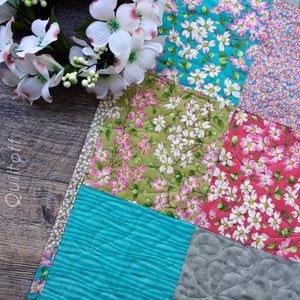 Available now: baby quilt, bright, scrappy look, floral, dogwood
