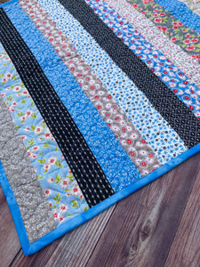 Available now: strips baby quilt, blue black ruby